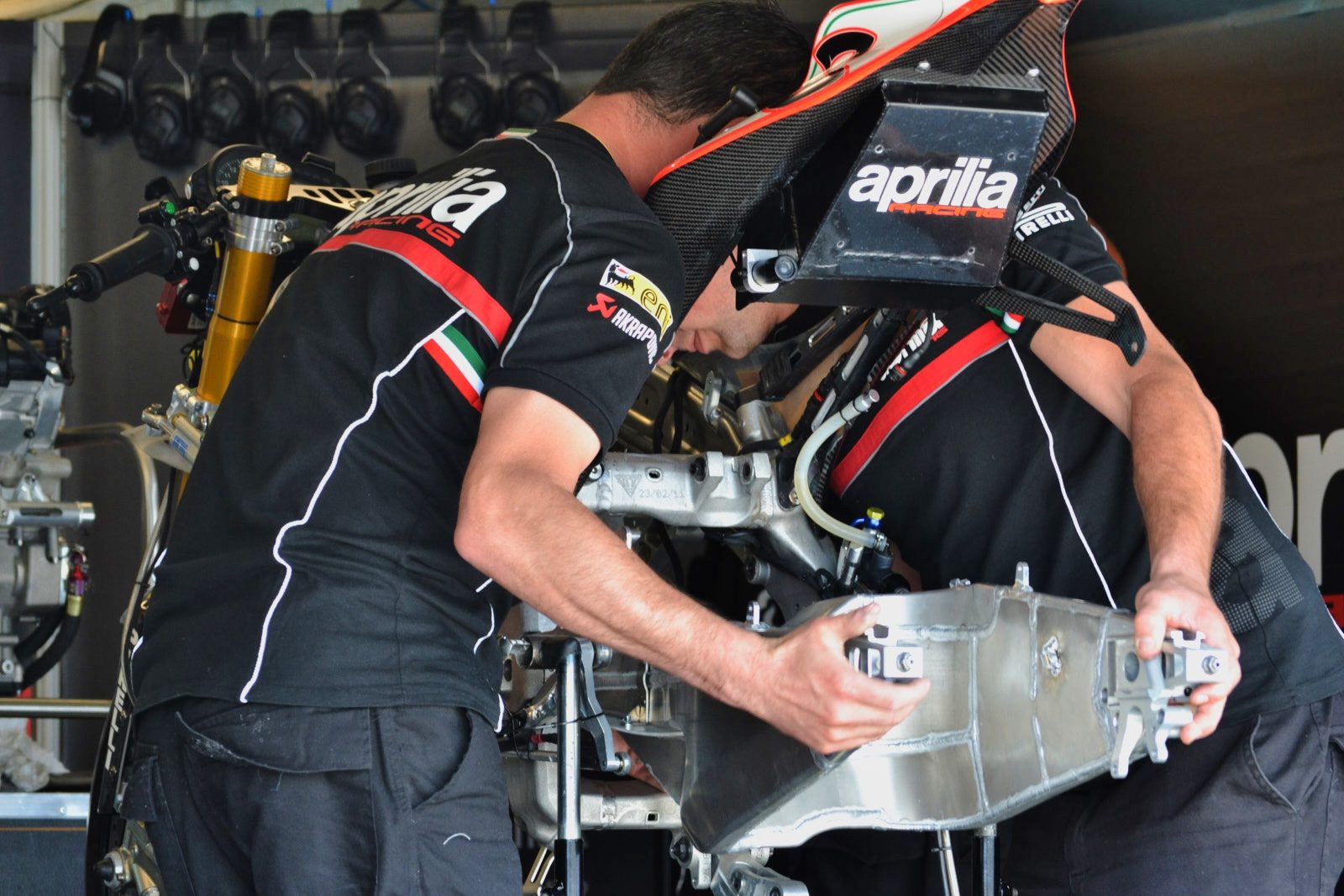 Aprilia factory technicians install the swingarm on Max Biaggi's 2012 championship-winning RSV4 Factory bike.